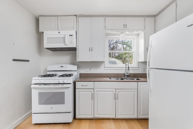 kitchen featuring white cabinetry, white appliances, sink, and light hardwood / wood-style flooring