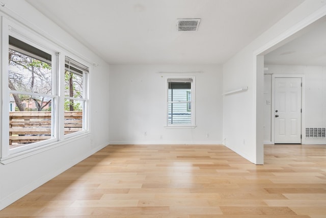 empty room with light hardwood / wood-style flooring