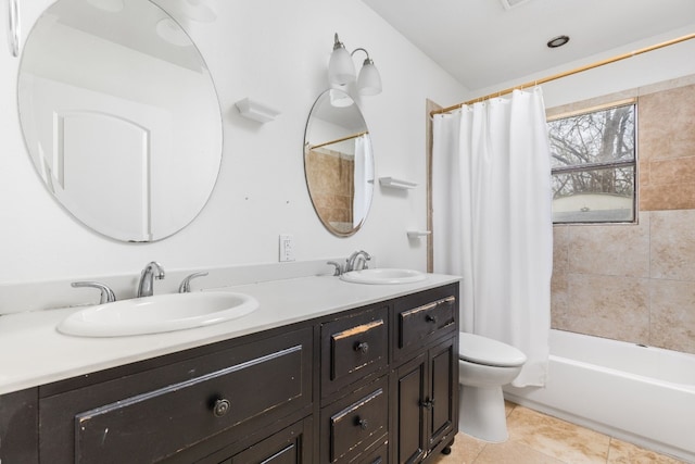 full bathroom featuring shower / tub combo with curtain, tile patterned floors, toilet, and vanity