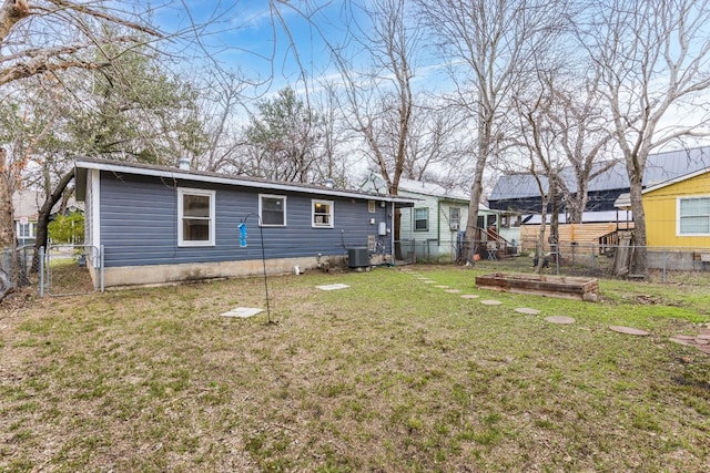 back of property featuring a yard and central AC unit