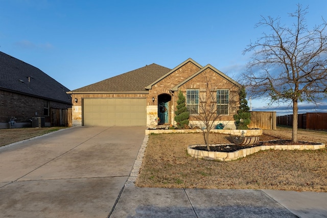 view of front of house with a garage and central air condition unit