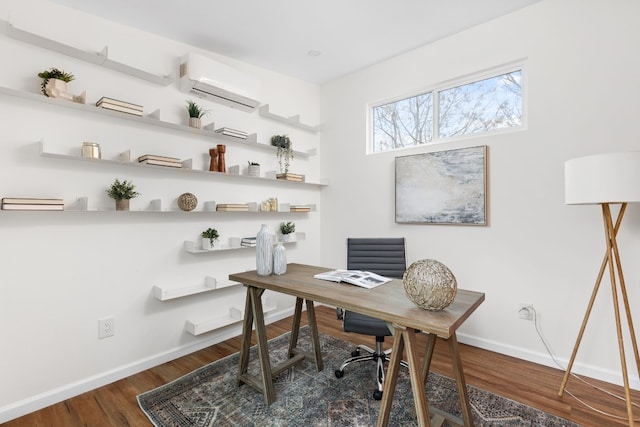 home office with dark hardwood / wood-style floors and a wall mounted air conditioner