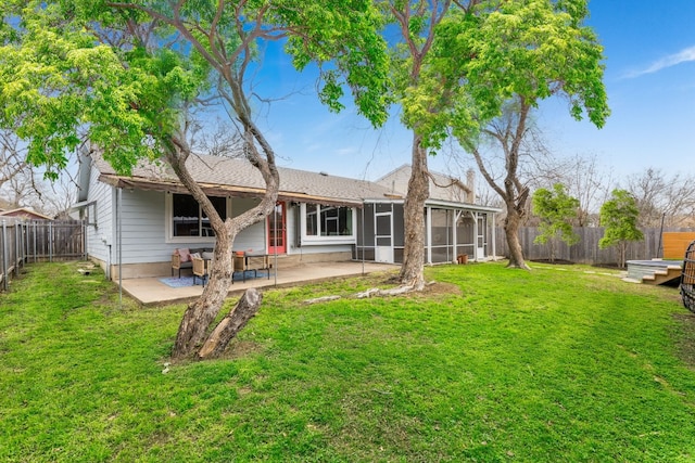 back of house featuring a patio, a sunroom, and a lawn