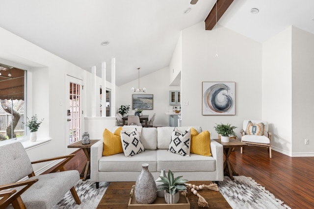 living room featuring wood-type flooring, high vaulted ceiling, an inviting chandelier, and beam ceiling