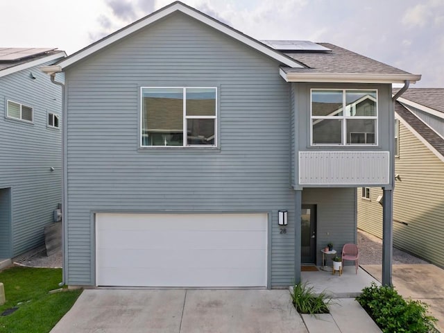 view of front of home featuring a garage and solar panels