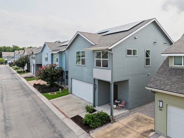 view of front of home featuring a garage and solar panels