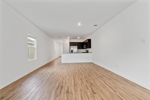 125 Mica Trl, Maxwell, TX 78656 - unfurnished living room featuring light wood finished floors, recessed lighting, and baseboards