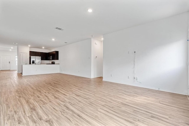 125 Mica Trl, Maxwell, TX 78656 - unfurnished living room with light wood-style flooring, recessed lighting, and baseboards