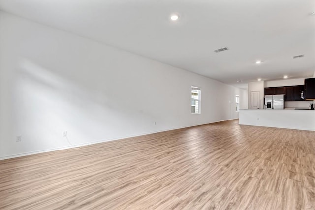 125 Mica Trl, Maxwell, TX 78656 - unfurnished living room with light wood-type flooring, recessed lighting, and baseboards