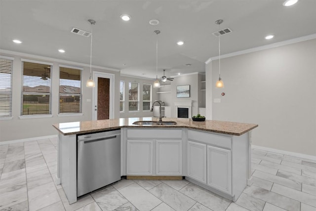 kitchen featuring sink, stainless steel dishwasher, hanging light fixtures, and a center island with sink