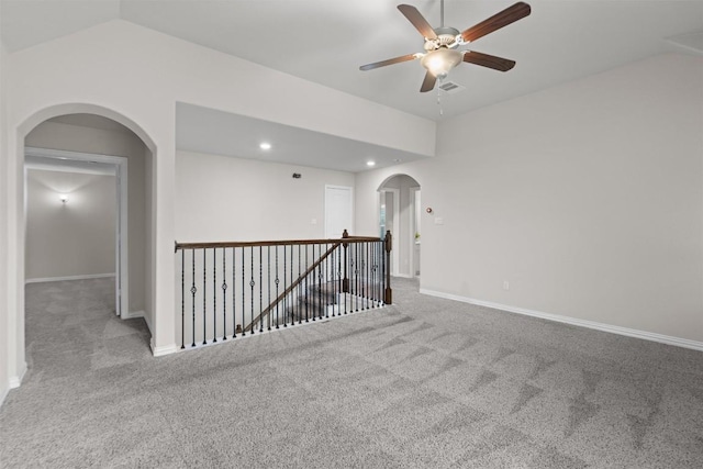 carpeted empty room with lofted ceiling and ceiling fan