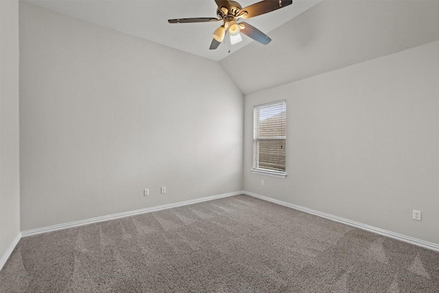 carpeted empty room with vaulted ceiling and ceiling fan