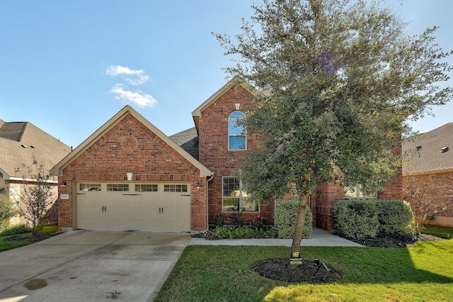 traditional-style house with brick siding, an attached garage, concrete driveway, and a front yard