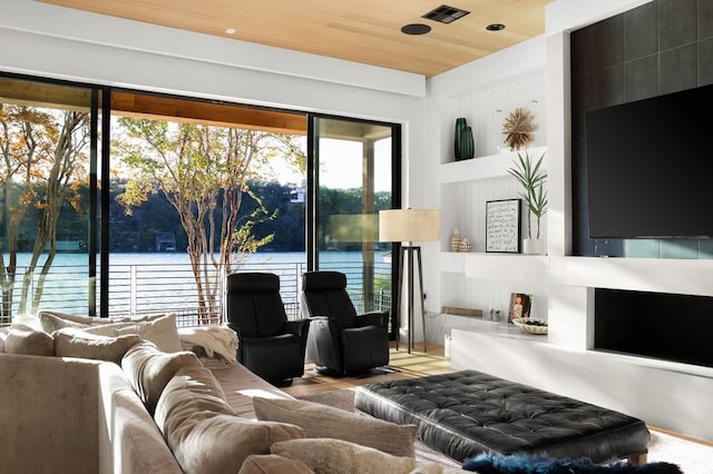 living room featuring wood ceiling and a water view