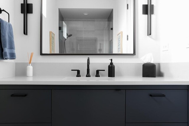 bathroom with vanity and a shower with shower door