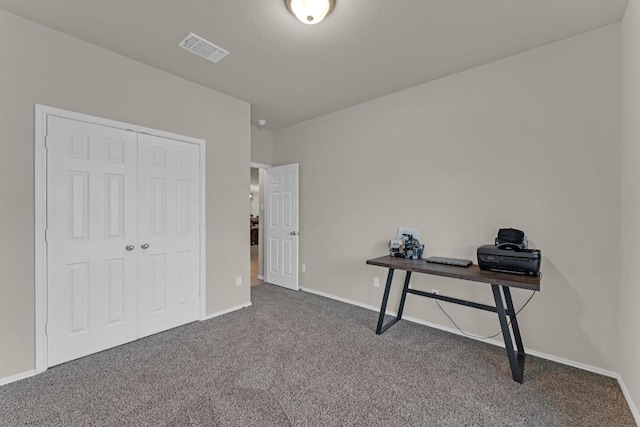 office area featuring visible vents, dark carpet, and baseboards