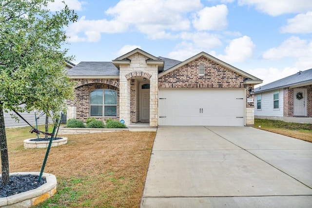 french country home featuring driveway, a garage, brick siding, stone siding, and a front yard