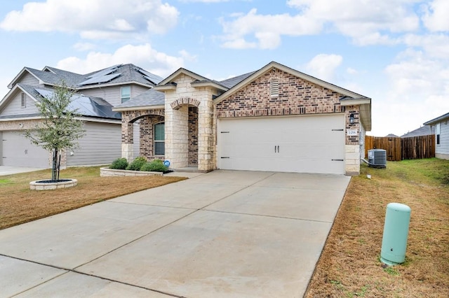 view of front of house with a garage, concrete driveway, a front yard, and fence