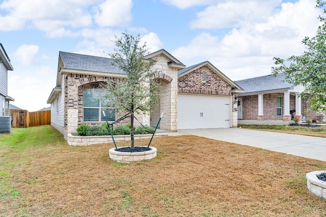 view of front facade with an attached garage, brick siding, fence, concrete driveway, and a front yard