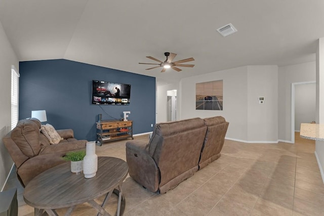 living area with light tile patterned floors, visible vents, baseboards, vaulted ceiling, and a ceiling fan