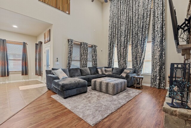 living room with wood-type flooring and a high ceiling