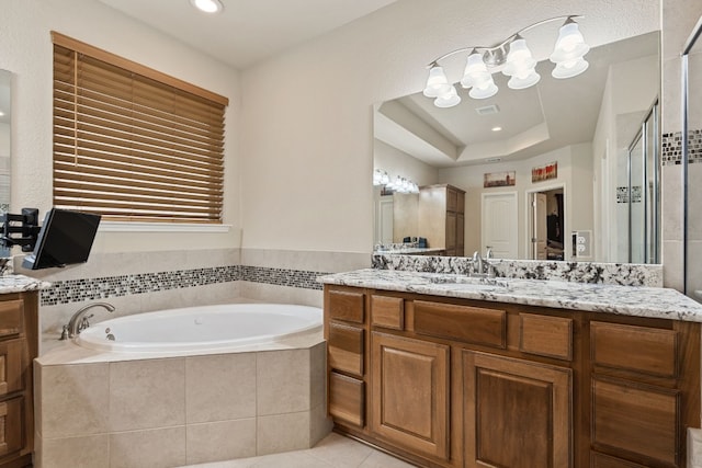bathroom with vanity, a tray ceiling, independent shower and bath, and tile patterned flooring