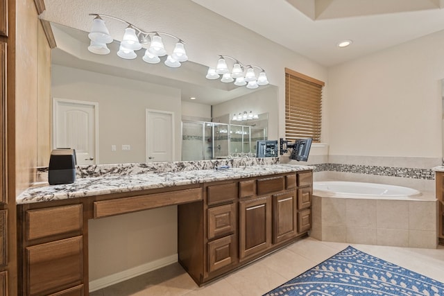 bathroom with tile patterned flooring, vanity, and shower with separate bathtub