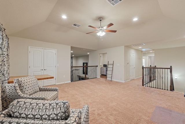 sitting room with lofted ceiling, light colored carpet, and ceiling fan