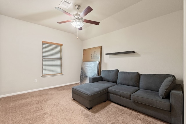 carpeted living room with ceiling fan and lofted ceiling