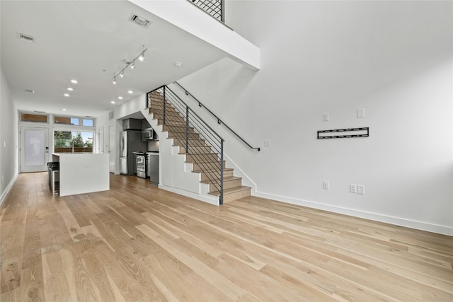 unfurnished living room featuring light hardwood / wood-style flooring