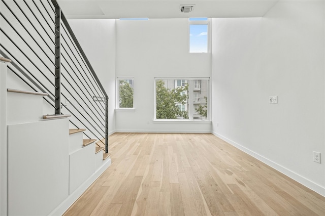 unfurnished living room with a healthy amount of sunlight and light hardwood / wood-style flooring