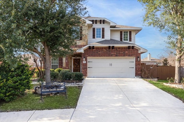 view of front facade with driveway, an attached garage, fence, and brick siding