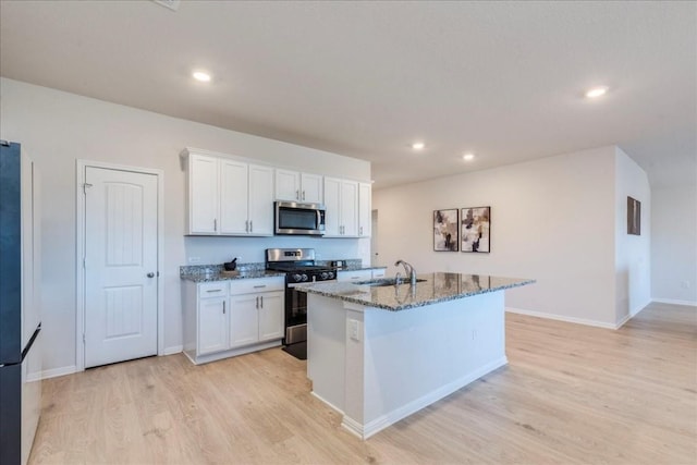 2501 Bear Juice Vw, Leander, TX 78641 - kitchen with appliances with stainless steel finishes, a sink, light wood-style floors, stone countertops, and white cabinets