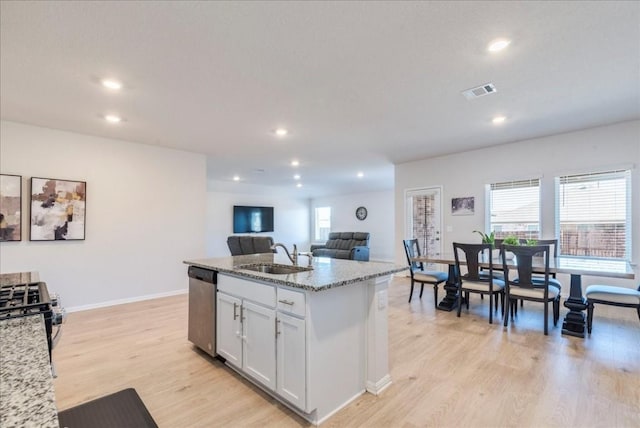 2501 Bear Juice Vw, Leander, TX 78641 - kitchen with a sink, appliances with stainless steel finishes, light stone countertops, light wood-type flooring, and recessed lighting