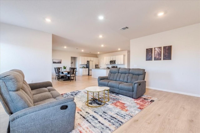 2501 Bear Juice Vw, Leander, TX 78641 - living area featuring light wood-type flooring, recessed lighting, and baseboards