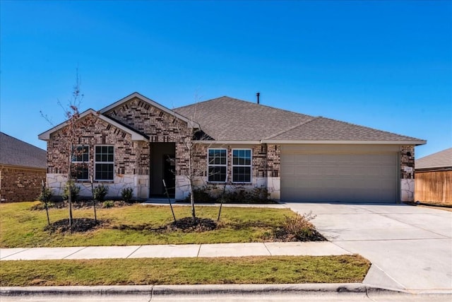 2501 Bear Juice Vw, Leander, TX 78641 - ranch-style home featuring an attached garage, concrete driveway, a front lawn, and stone siding
