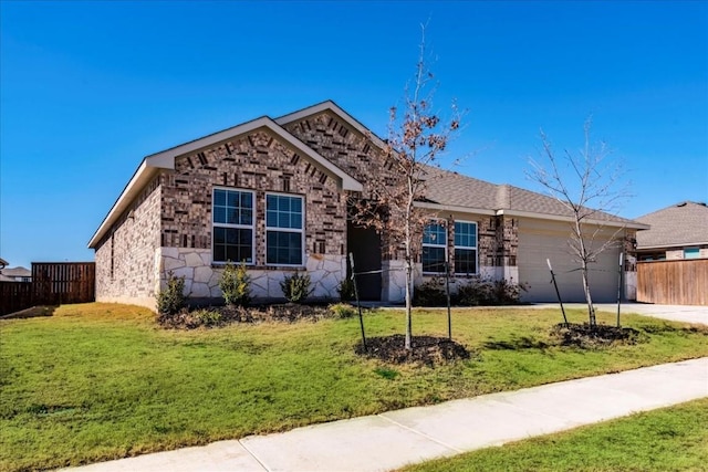 view of front of property featuring a garage and a front yard