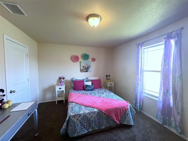 carpeted bedroom featuring a textured ceiling