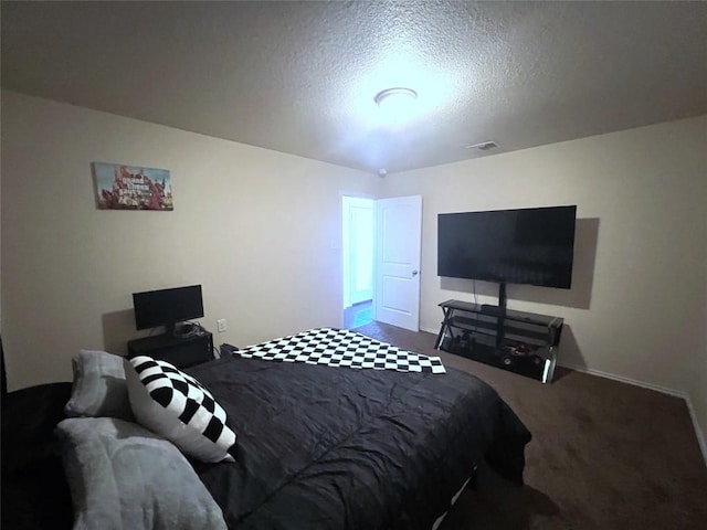 bedroom with carpet floors and a textured ceiling