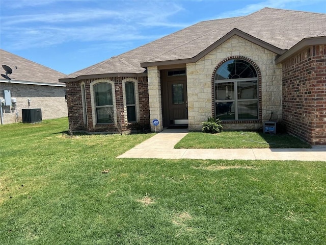 view of front facade with central AC unit and a front lawn