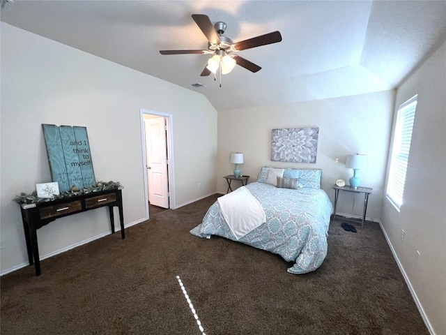 carpeted bedroom with vaulted ceiling and ceiling fan