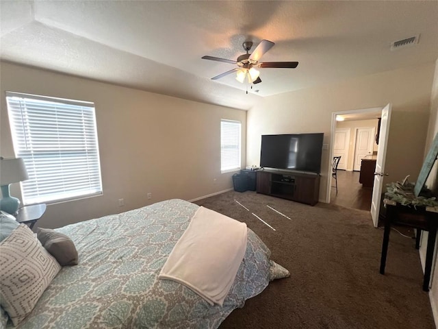 bedroom featuring ceiling fan and dark carpet