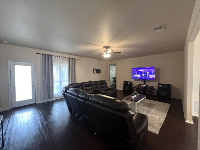 living room with visible vents, baseboards, ceiling fan, and wood finished floors