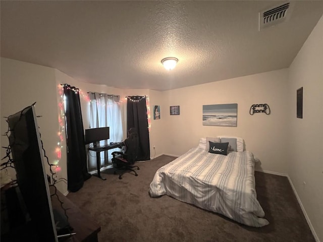 carpeted bedroom featuring a textured ceiling