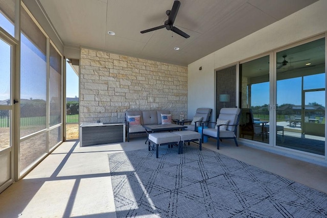 sunroom / solarium featuring ceiling fan