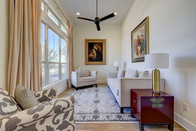 sitting room with ceiling fan and light hardwood / wood-style flooring