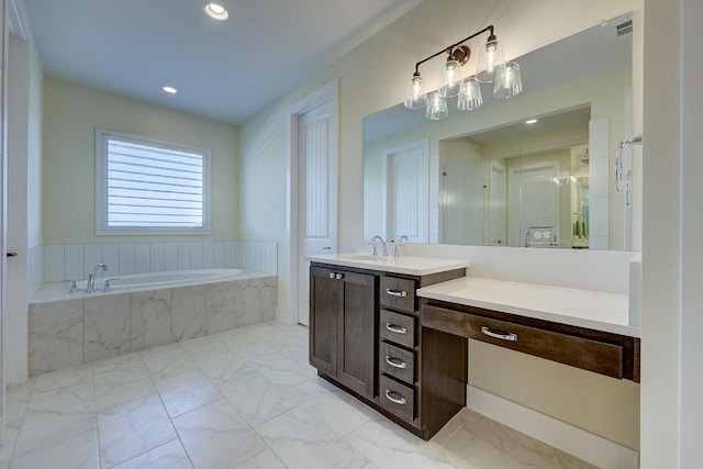 bathroom featuring vanity and a relaxing tiled tub