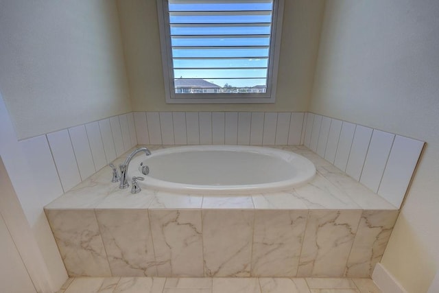 bathroom featuring tiled tub