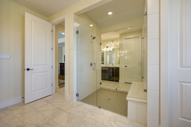 bathroom featuring vanity and a shower with door