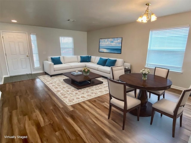 living room with an inviting chandelier and hardwood / wood-style floors